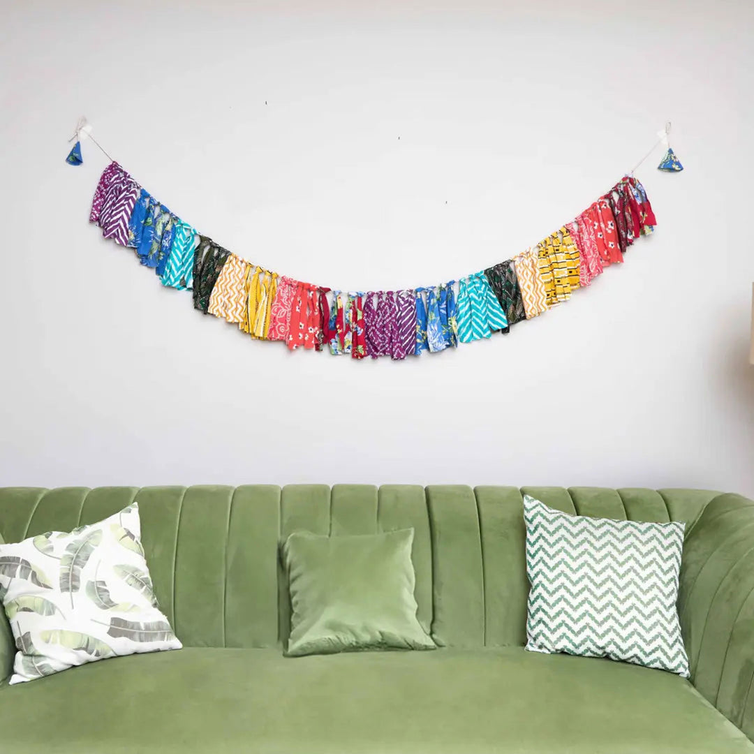 Upcycled Fabric Rainbow Fringe Streamer Bunting - Hanging on Wall Above Couch