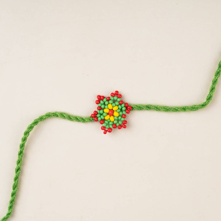 Handcrafted Glass Beads Sitara Rakhi 7 - Close-up of green rakhi thread design