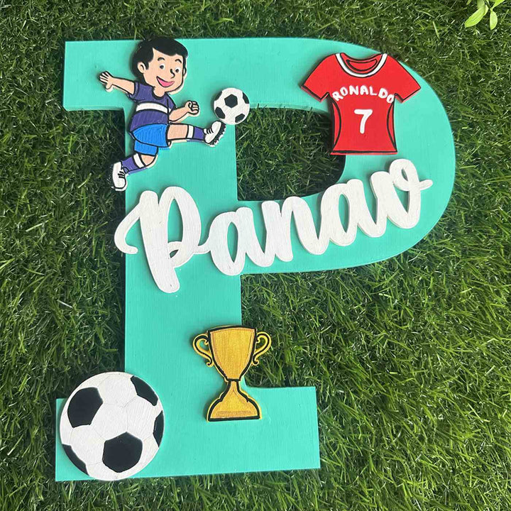Handcrafted Personalized Kids Football Themed Monogram Mdf Nameplate 6 - Top-down View on Grass Surface