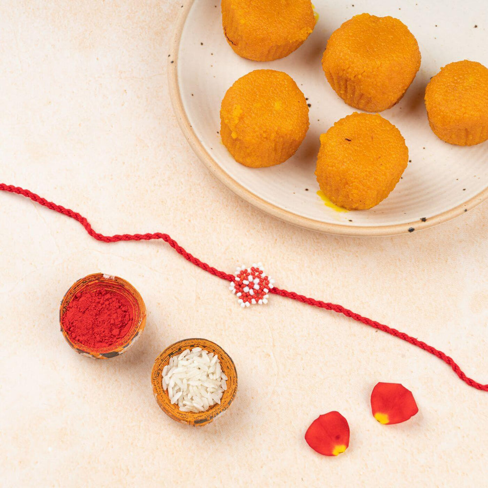 Handcrafted Glass Beads Sitara Rakhi 2 - Rakhi with Festive Items Flat Lay