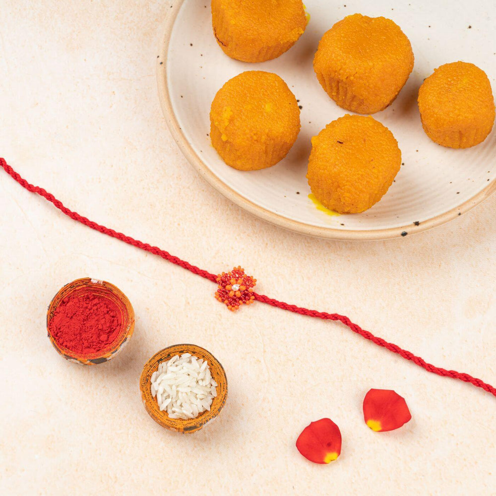 Handcrafted Glass Beads Sitara Rakhi 5 - Rakhi with traditional items flat lay