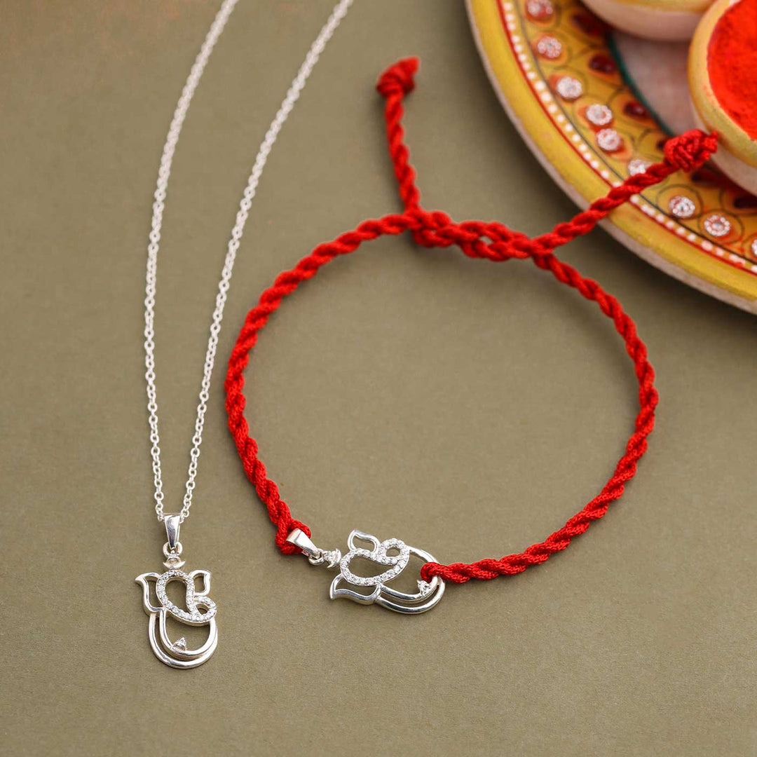 Handmade Ganesha Design Religious Silver Rakhi For Brother - Pendant and bracelet on ethnic plate