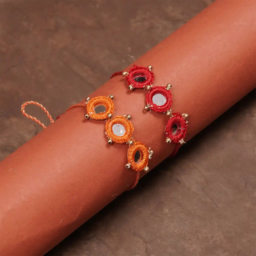 Handmade Mirror Work Red And Orange Rakhi With Roli Chawal Set Of 2 - Bracelet Wrapped on Arm