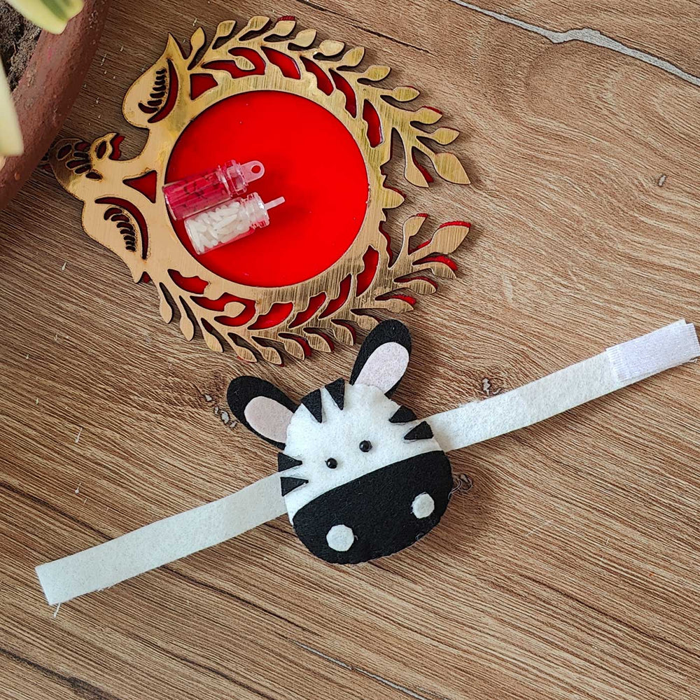 Handmade Zebra Theme Felt Kids Rakhi With Roli Chawal - Full View on Surface