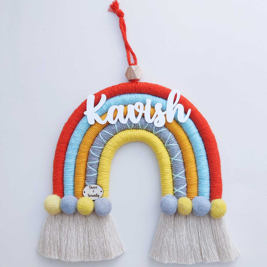 Personalized Handmade Macrame Orange And Yellow Pom Pom Rainbow Kids Name Plate With 3D Letters - Front View Hanging Display