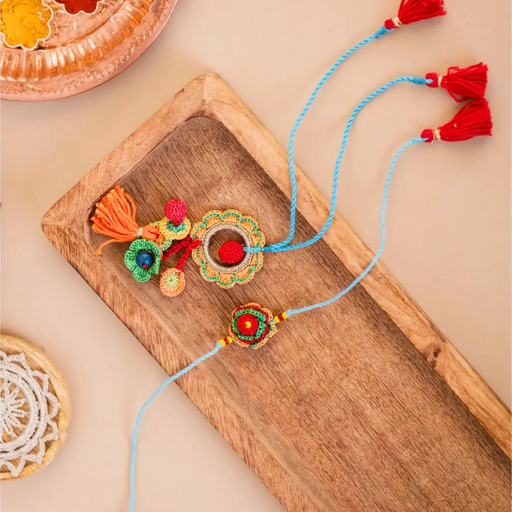 Handmade Crochet Floral Garden Bhaiya Bhabhi Rakhi With Roli Chawal Set Of 2 - Top View Showing Tassels