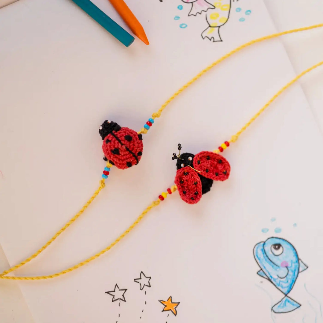 Handmade Crochet Mood Beetles Theme Kids Rakhi With Roli Chawal Set Of 2 - Ladybug Charms Arrangement Close-up
