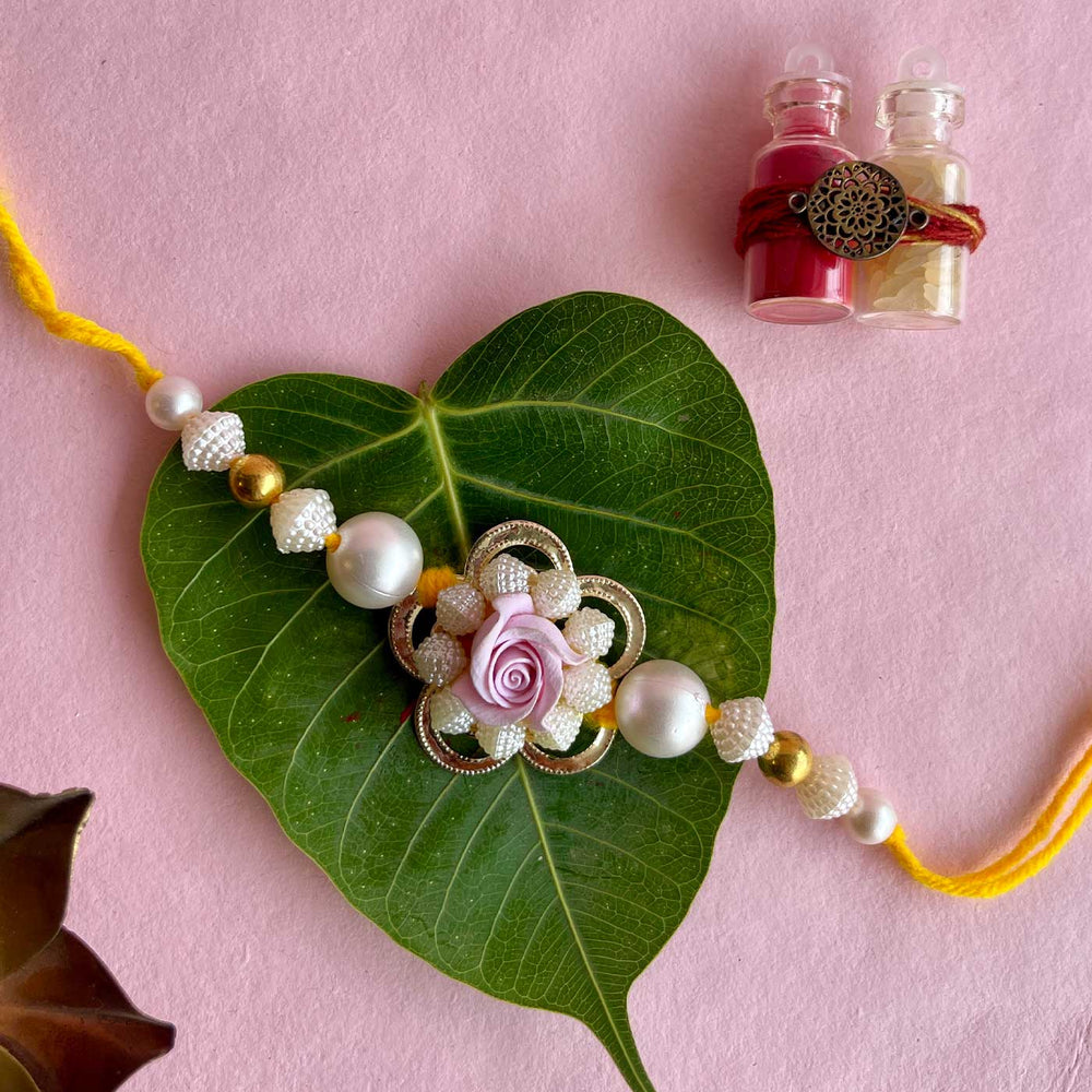 Handmade Purple Flower Design Pearl And Stone Bhaiya Bhabhi Rakhi - Single Strand Display with Leaf