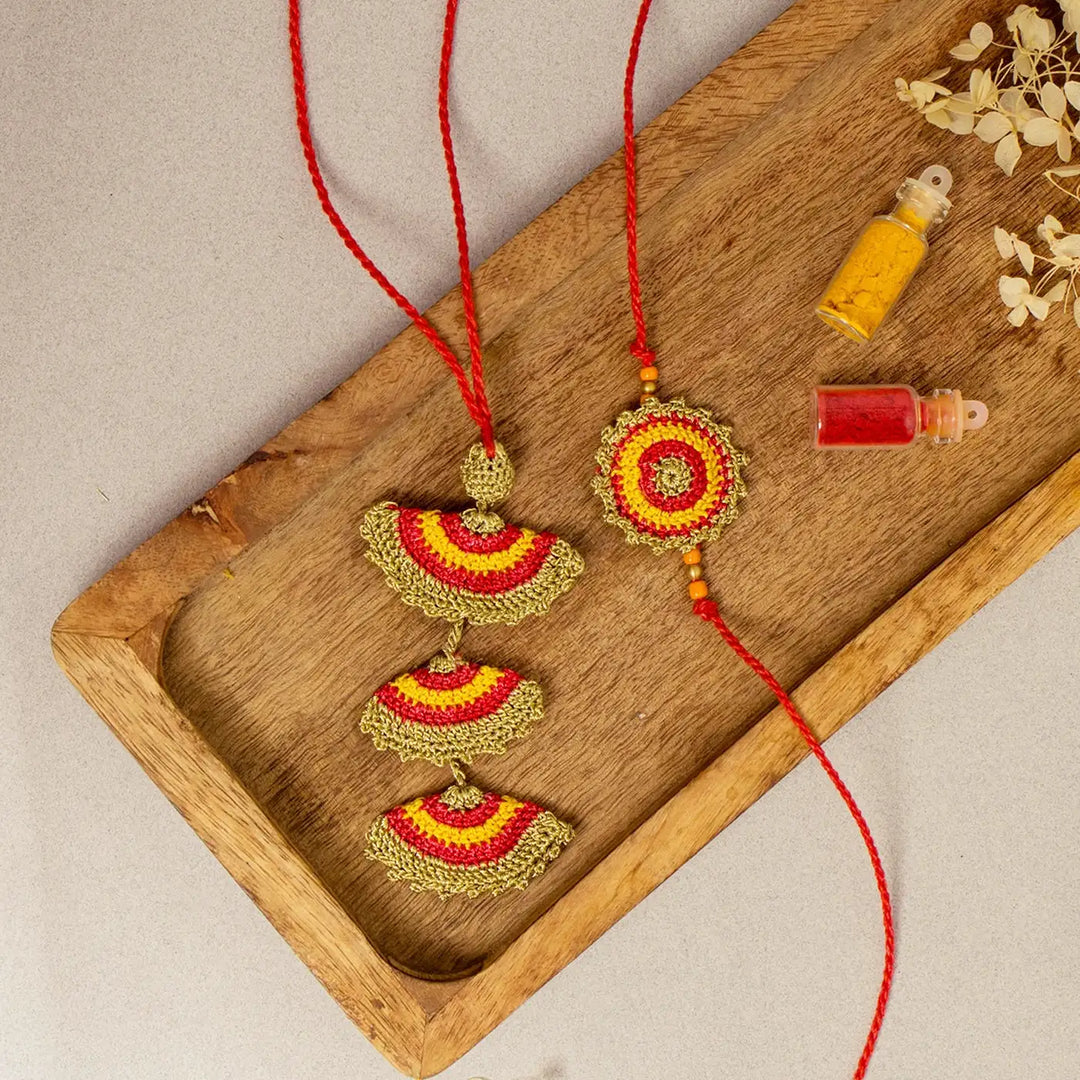 Handmade Crochet Tarang Bhaiya Bhabhi Rakhi With Roli Chawal Set Of 2 - Flat Lay Display with Decorative Bottles