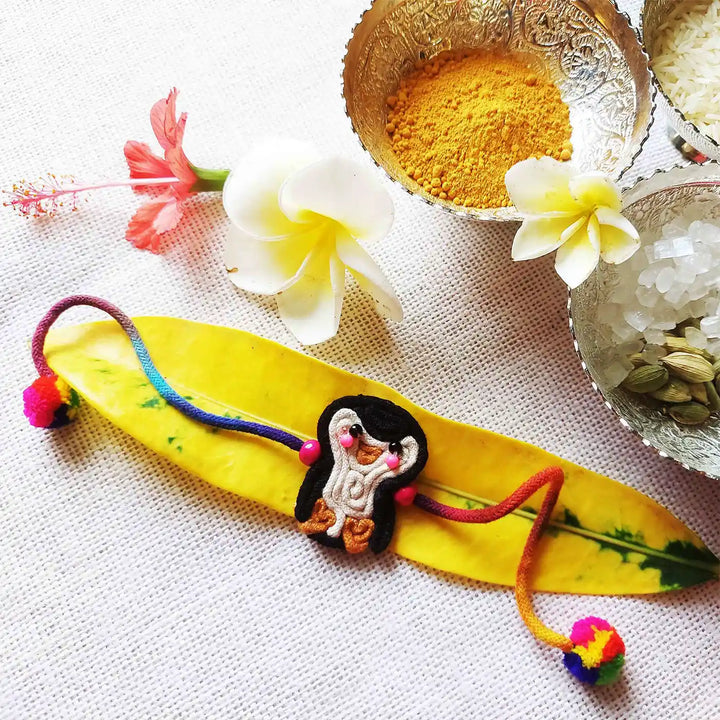 Handmade Dori Work Cute Penguin Kids Rakhi With Roli Chawal - Styled with Decorative Elements