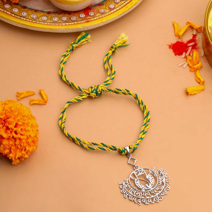 Handmade Ganesha Theme Religious Silver Lumba Rakhi For Bhabhi - Close-up of Rakhi Bracelet
