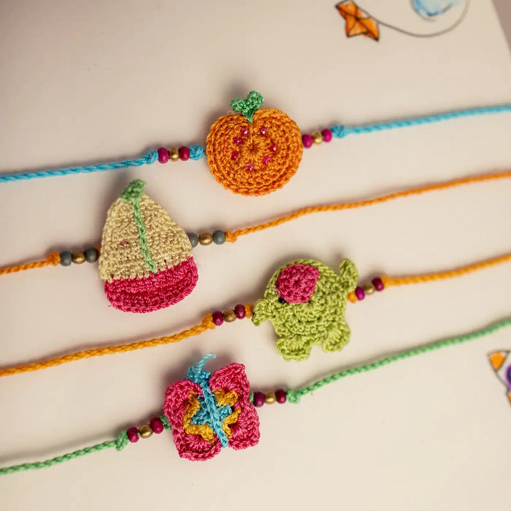 Handmade Crochet Funtime Rakhi With Roli Chawal Set Of 4 - Close-up of crochet charms