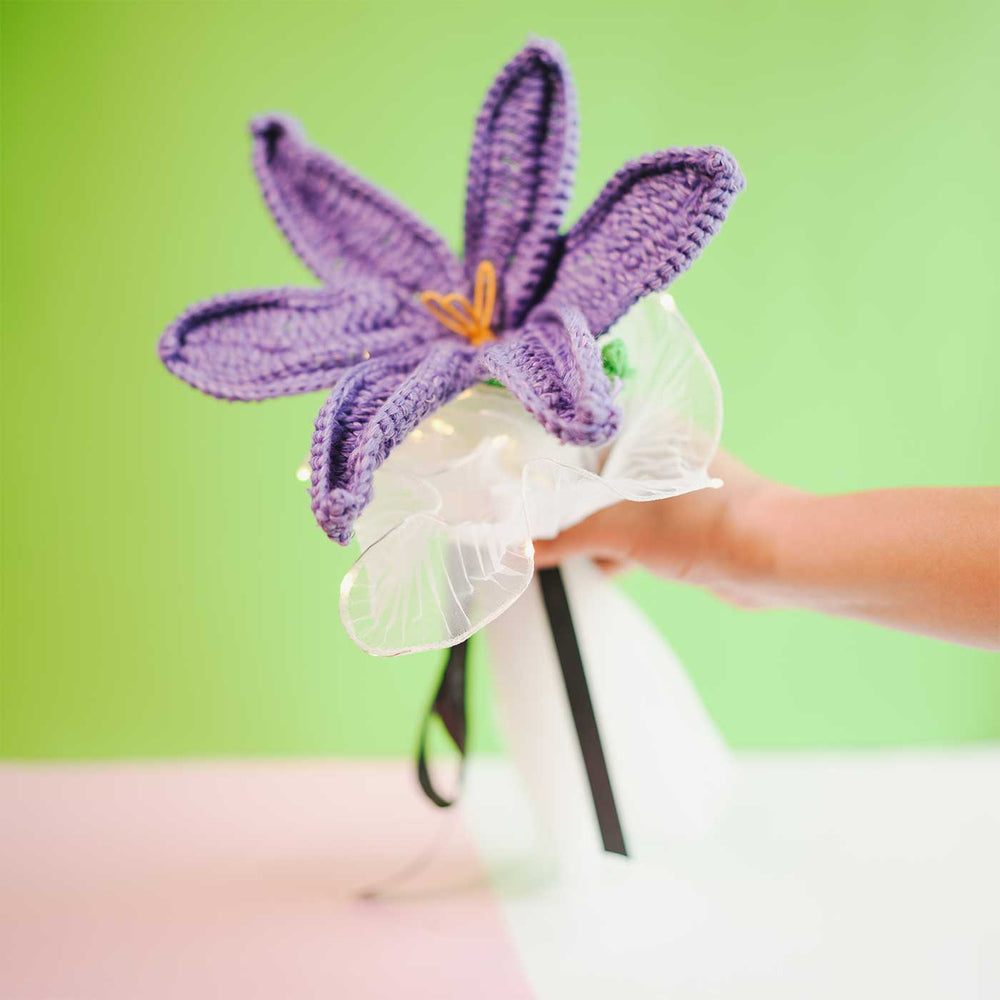Personalized Handmade Crochet Purple Lily Rakhi Hamper Includes 1 Crochet Flower 1 Message Card And 1 Rakhi And Roli Chawal - Handheld Front View