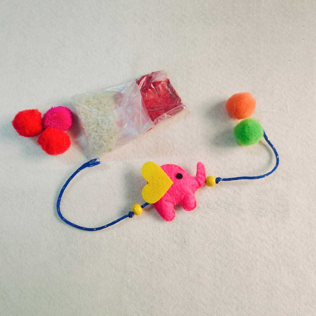 Customized Handmade Beaded Elephant Theme Pom Pom Felt Rakhi With Roli Chawal For Kids - Included Items Display