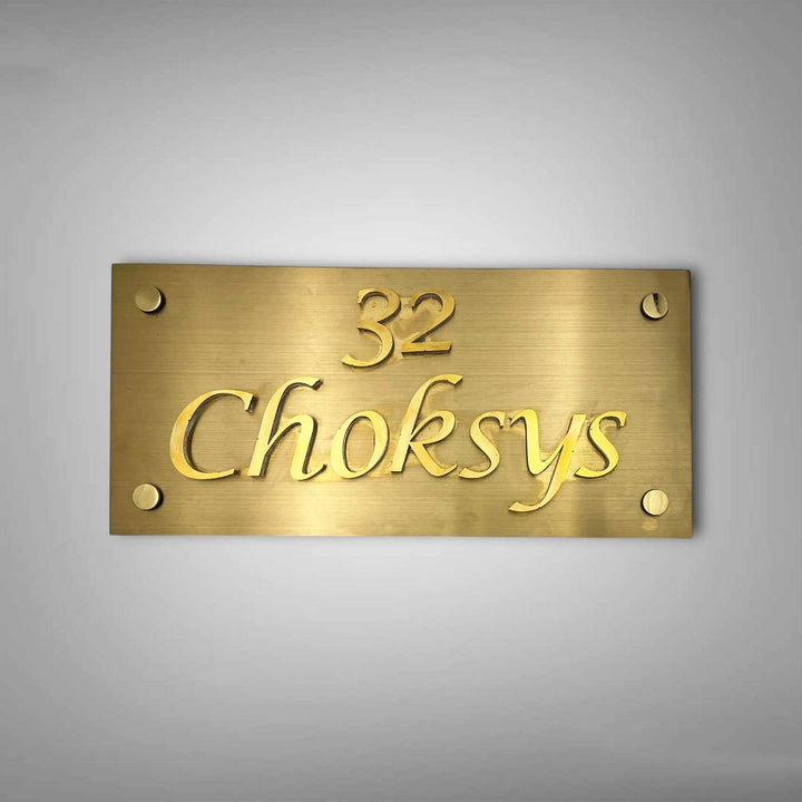 Personalized Weatherproof Rectangle Engraved Gold Stainless Steel Name Plate - Front View on Wall Background