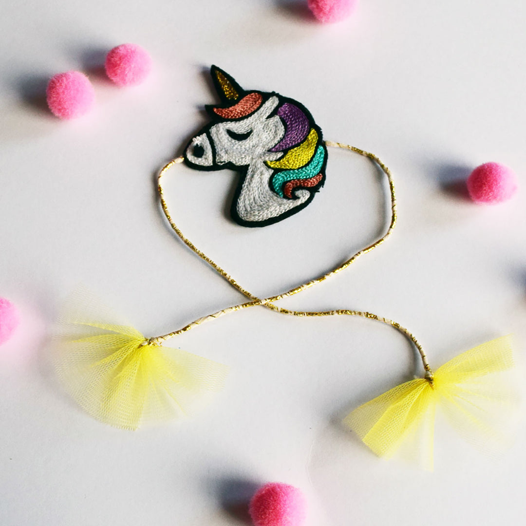 Handmade Unicorn Felt Kids Rakhi - Flat Lay with Accessories