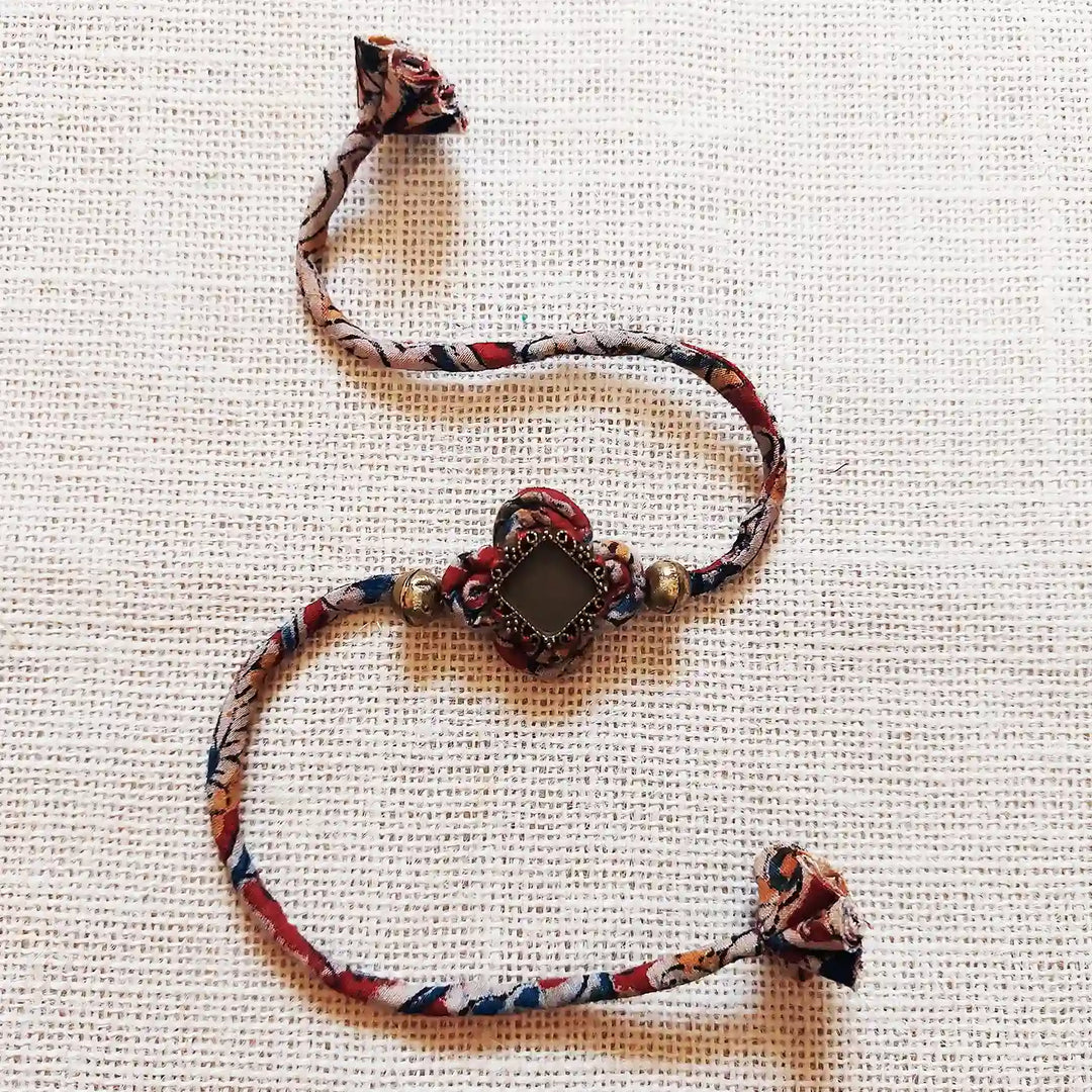 Handmade Dori Work Kalamkari Bhaiya Bhabhi Rakhi With Roli Chawal Set Of 2 - Bracelet Alone Front View