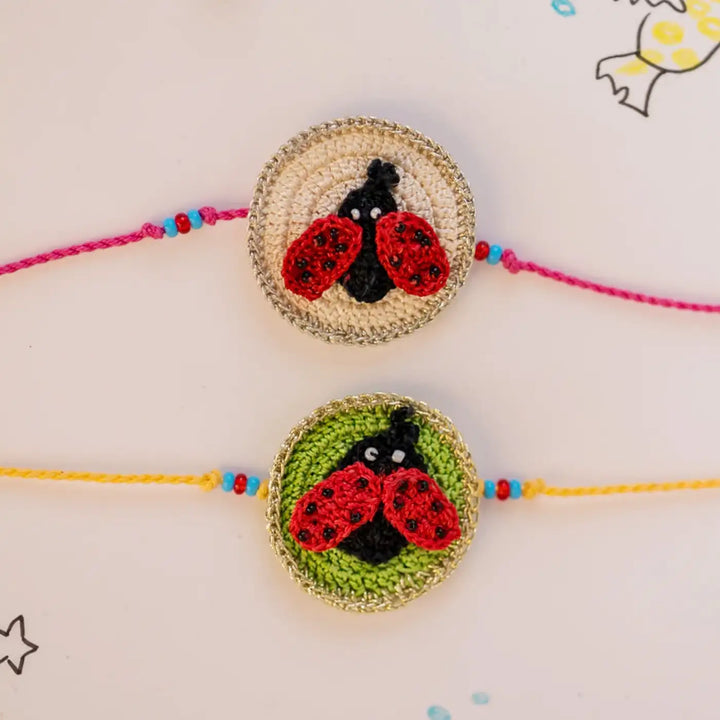 Handmade Crochet Beetle Theme Kids Rakhi With Roli Chawal Set Of 2 - Close-up of two ladybug bracelets