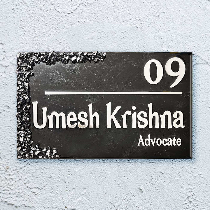 Personalized Black And Silver Resin Name Plate - Front View on Textured Wall