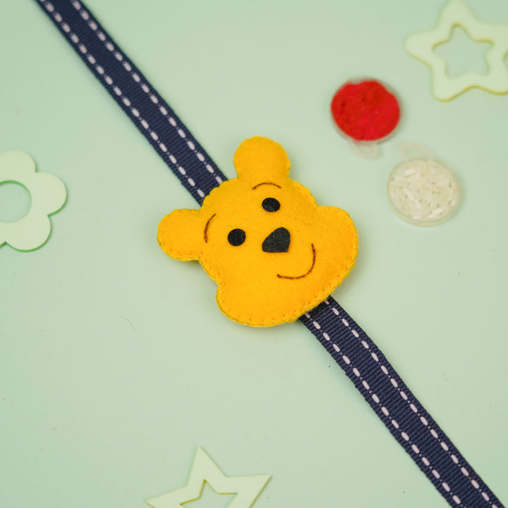 Handmade Pooh Theme Felt Kids Rakhi With Roli Chawal - Diagonal Strap View