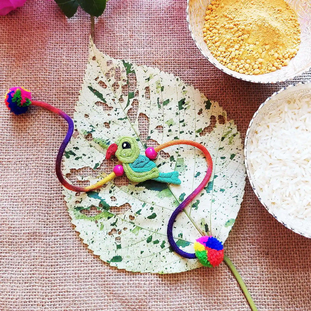 Handmade Dori Work Cute Parrot Kids Rakhi With Roli Chawal - Styled with Traditional Ingredients