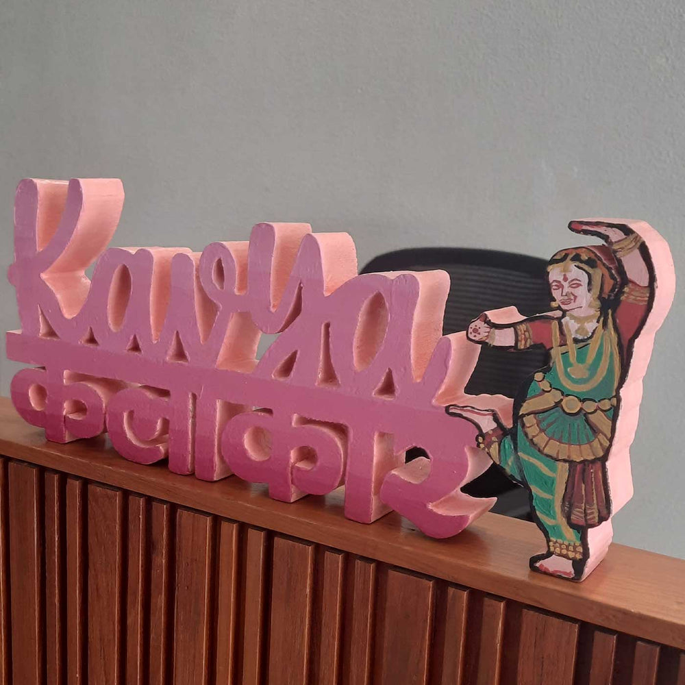 Personalized Handmade Kalakaar Wooden Cutout Name Plate For Girls - Front angled view on shelf