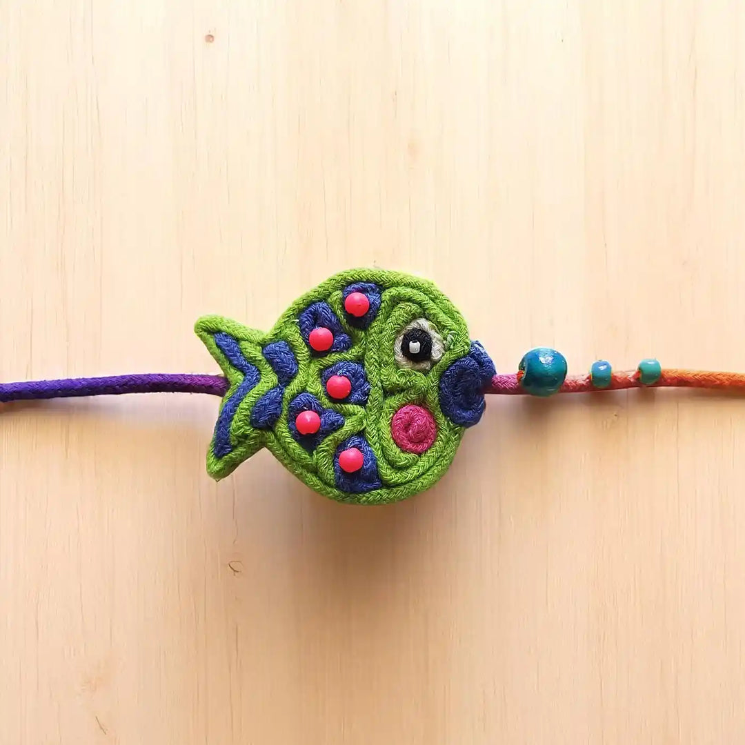 Handmade Dori Work Beaded Cute Fish Kids Rakhi With Roli Chawal - Close-up Front View