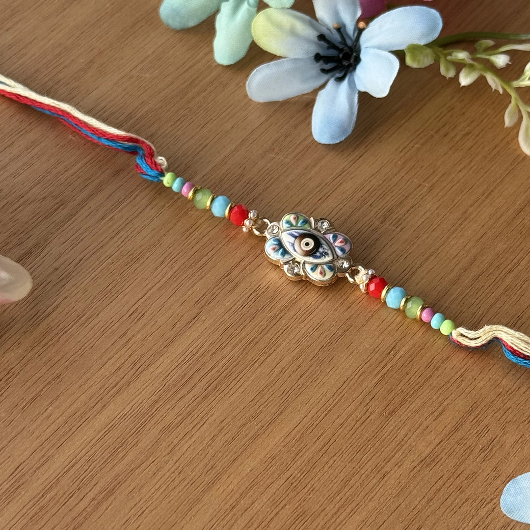 Handmade Multicolor Beaded Evil Eye Rakhi With Roli Chawal - Single bracelet flat lay view