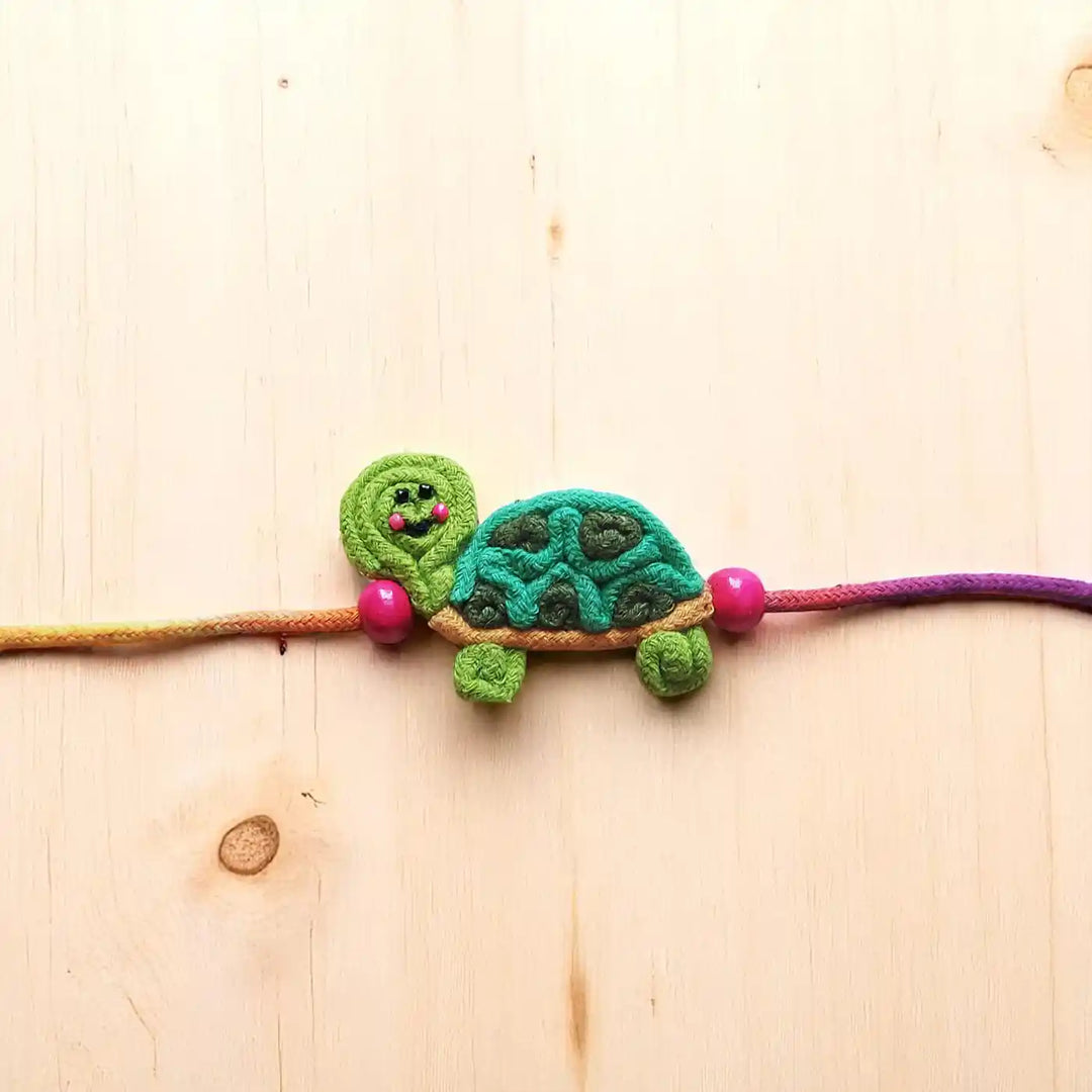 Handmade Dori Work Cute Tortoise Kids Rakhi With Roli Chawal - Close-up Front View