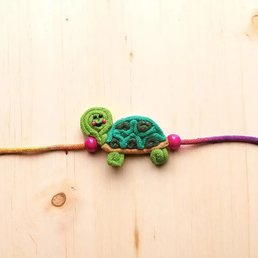 Handmade Dori Work Cute Tortoise Kids Rakhi With Roli Chawal - Close-up Front View
