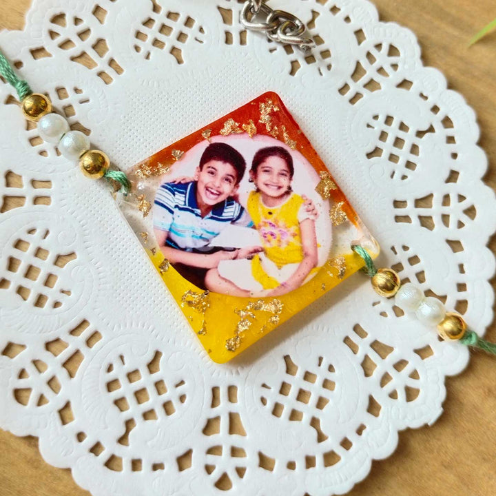 Photo Personalized Brother And Sister Design Resin Rakhi - Styled with Bracelet on Doily Background
