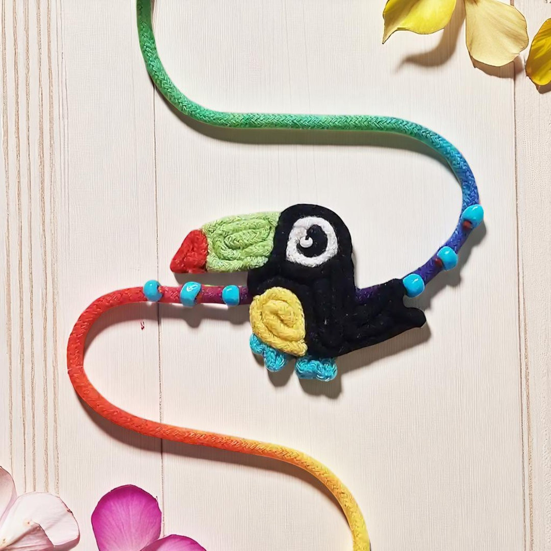 Handmade Dori Work Toucan Kids Rakhi With Roli Chawal - Front View on Light Background
