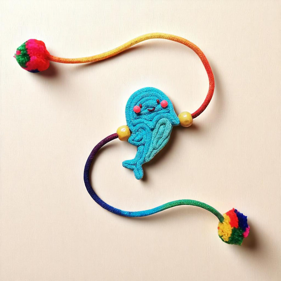Handmade Dori Work Blue Fish Kids Rakhi With Roli Chawal - Flat Lay View
