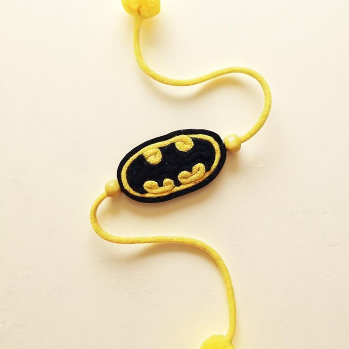 Handmade Dori Work Batman Kids Rakhi With Roli Chawal - Close-up of Symbol Detail
