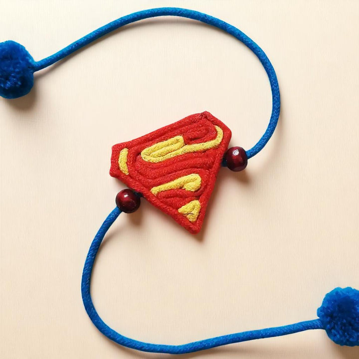 Handmade Dori Work Superman Kids Rakhi With Roli Chawal - Close-up of Central Emblem