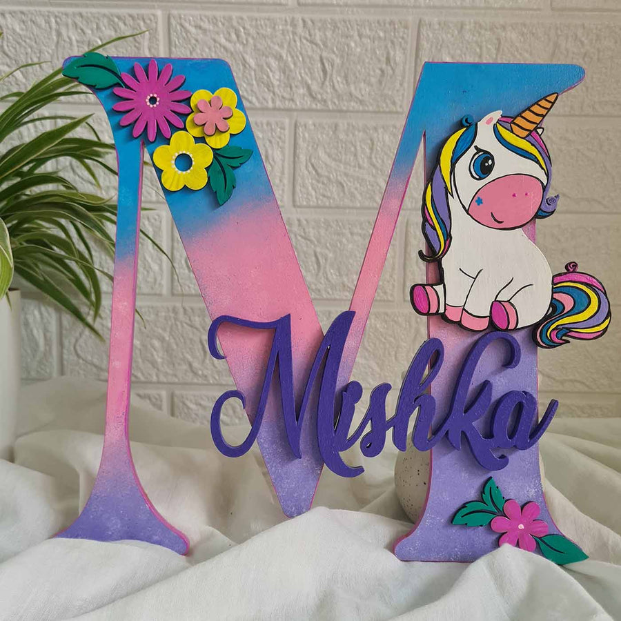 Unicorn Themed Monogram Kids Name Plate - Front View on Fabric Surface
