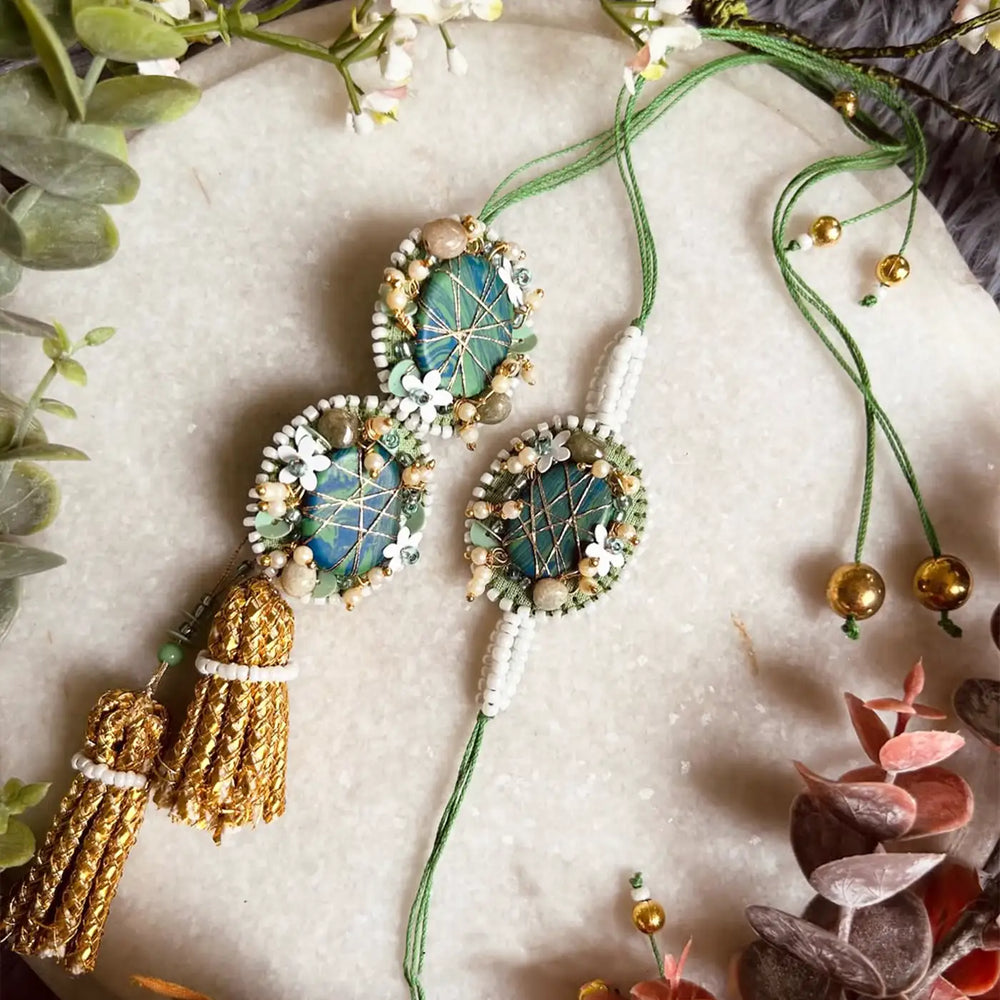 Hand Embroidered Beaded Moni Bhaiya Bhabhi Rakhi With Roli Chawal Set Of 2 - Full Set on Marble Surface