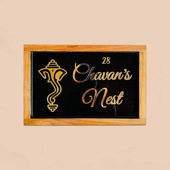 Personalized Ganesha Face Theme Resin Name Plate With Teak Wood Border For Couples - Front View on Neutral Background