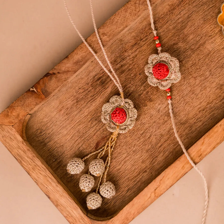 Handmade Crochet Shakti Bhaiya Bhabhi Rakhi With Roli Chawal Set Of 2 - Close-up of Crochet Flower Pair