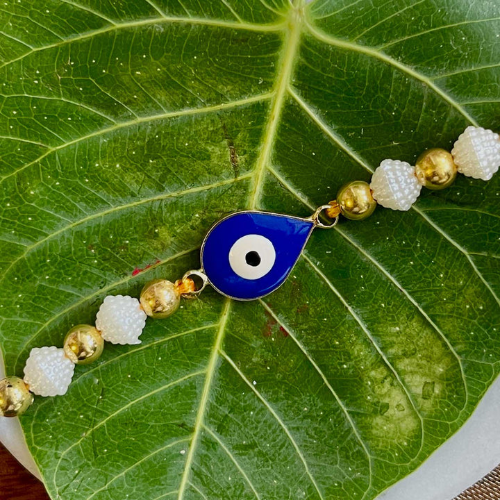 Handmade Evil Eye Design Metal Rakhi 10 - Close-up of central amulet