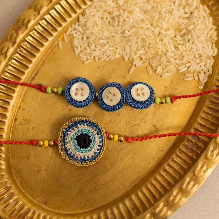 Handmade Crochet Noor And Nazar Evil Eye Rakhi With Roli Chawal Set Of 2 - Close-up on two bracelets