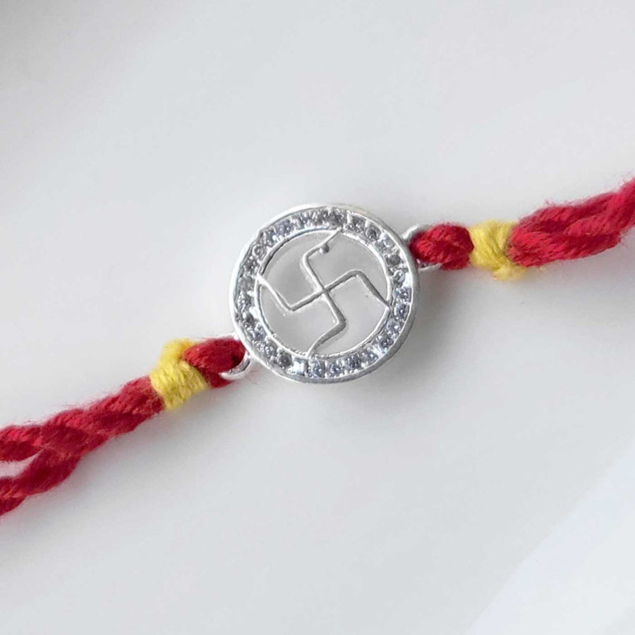 Handmade Swatik Design Silver Rakhi Hamper With Roli Chawal For Brother - Close-up of Rakhi centerpiece