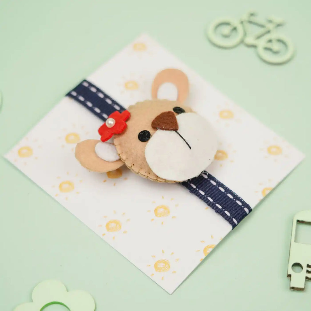 Handmade Bear Theme Felt Kids Rakhi With Roli Chawal - Angled View with Gift Card Background