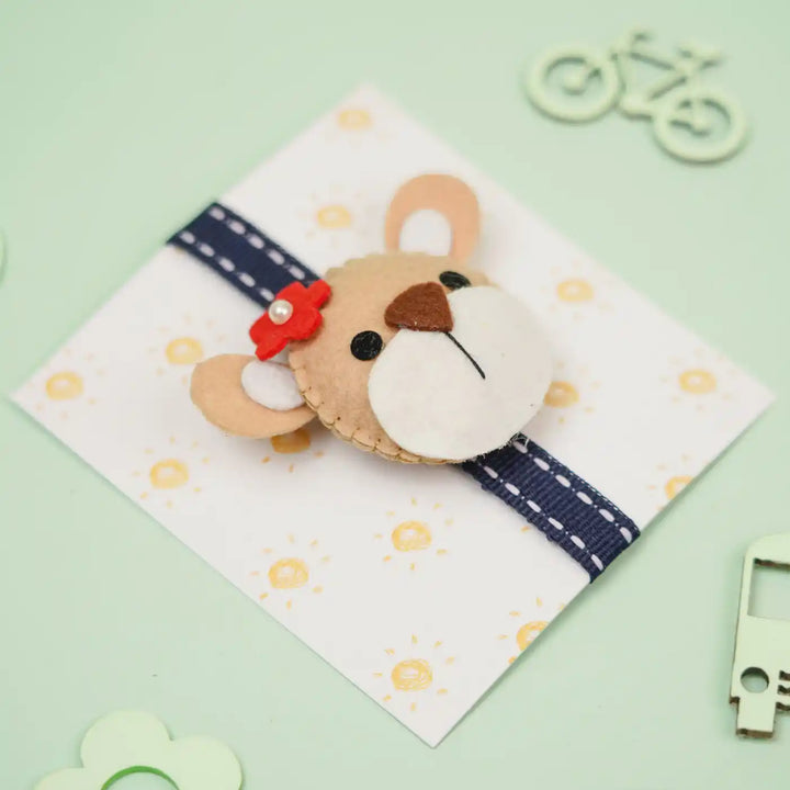 Handmade Bear Theme Felt Kids Rakhi With Roli Chawal - Angled View with Gift Card Background