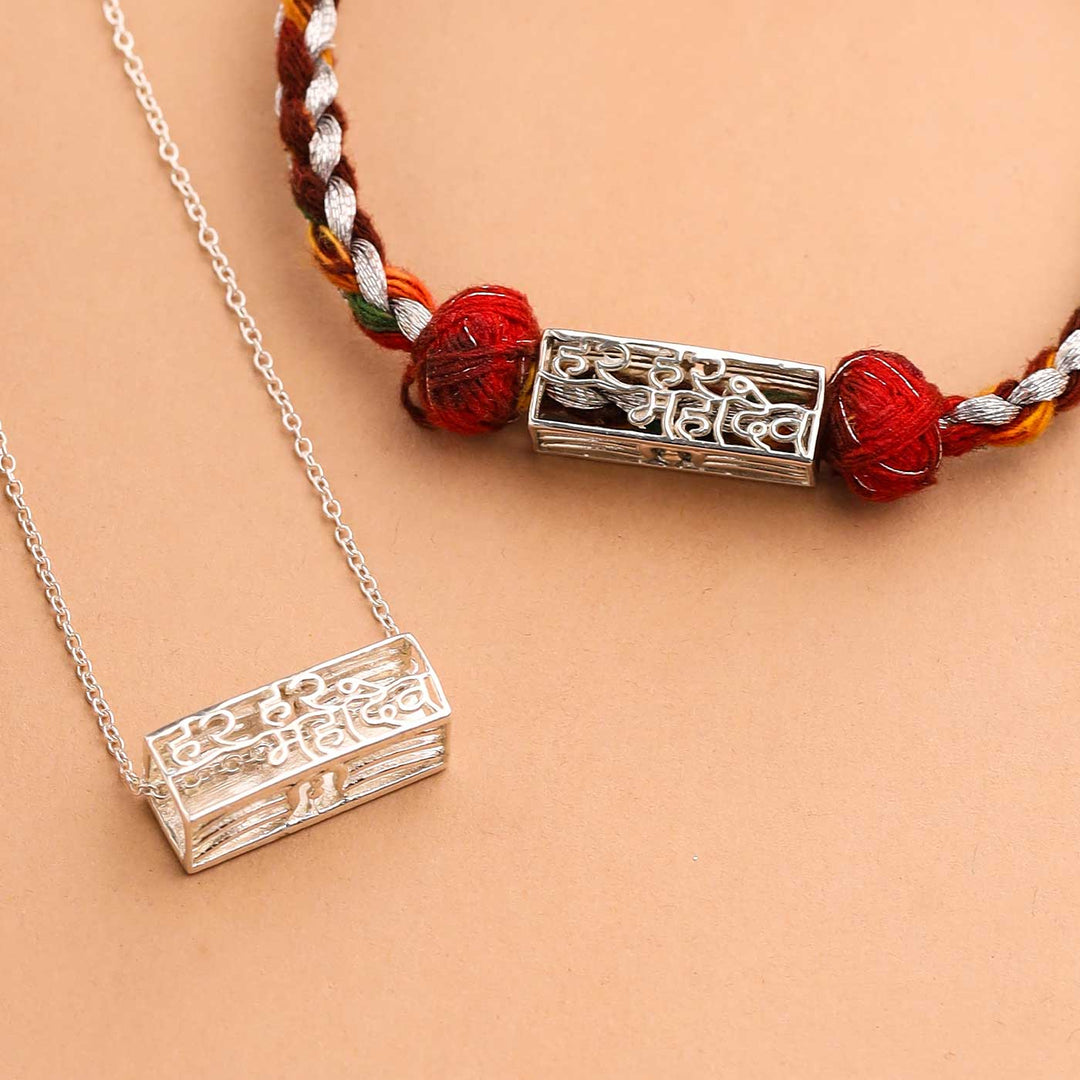 Handmade Har Har Mahadev Design Religious Silver Rakhi For Brother - Close-up of pendants on cords