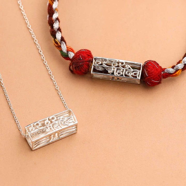 Handmade Har Har Mahadev Design Religious Silver Rakhi For Brother - Close-up of pendants on cords