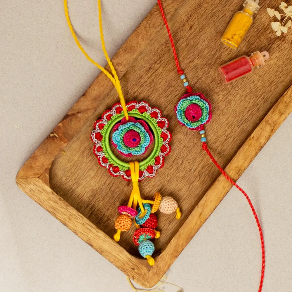 Handmade Crochet Rose Bhaiya Bhabhi Rakhi With Roli Chawal Set Of 2 - Close-up on wooden tray