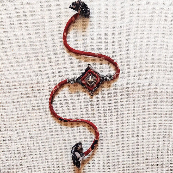 Handmade Dori Work Antique Metal Rakhi With Roli Chawal - Full length laid flat