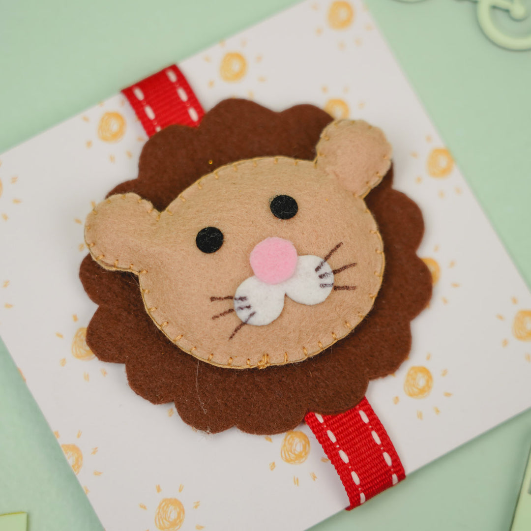 Handmade Lion Theme Felt Kids Rakhi With Roli Chawal - Front View on Cardboard Backing