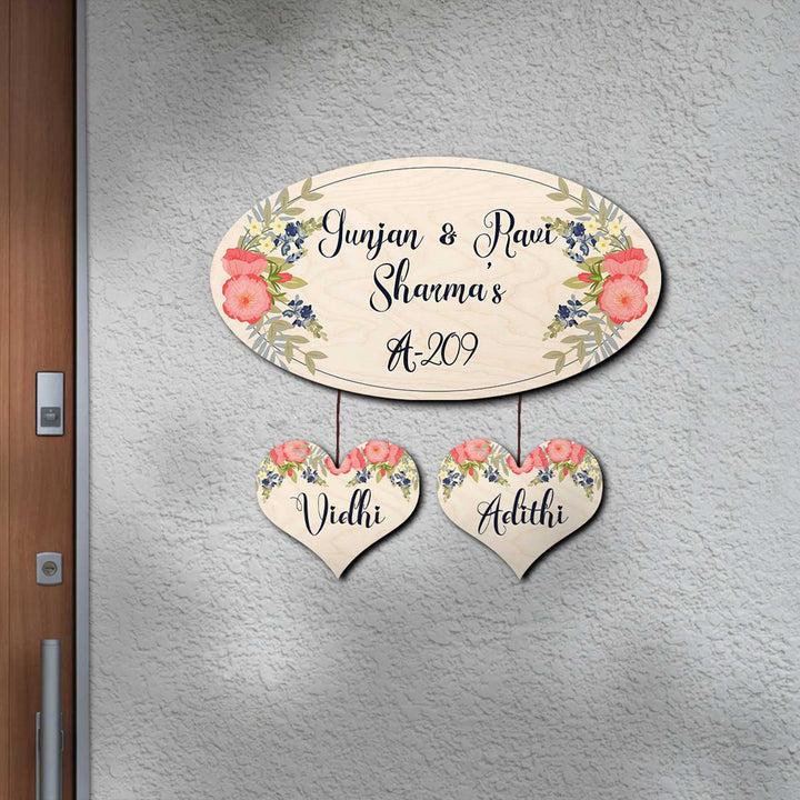 Printed White Floral Wooden Oval Nameplate For Couples - Mounted on Wall with Hanging Hearts